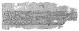 Fragment of tiraz, with a frieze of rabbits and stars in lozenges framed by two bands of Kufic
