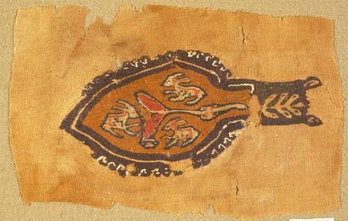 Spatulate polychrome tapestry panel with three rabbits encircling a stylized tree