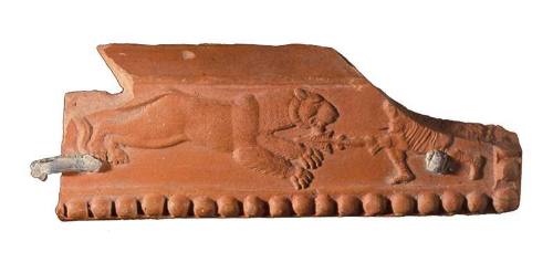 Part of a rim from a rectangular dish with relief applique depicting a hunting scene