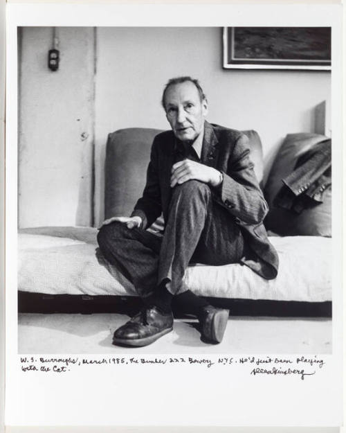 William Burroughs, NYC seated on bed