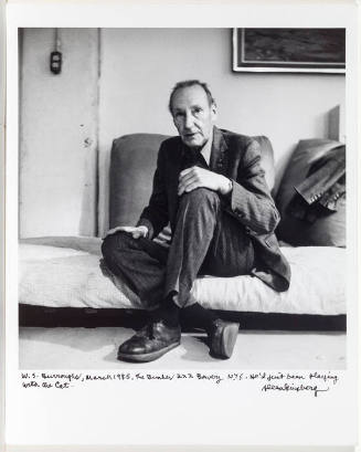 William Burroughs, NYC seated on bed
