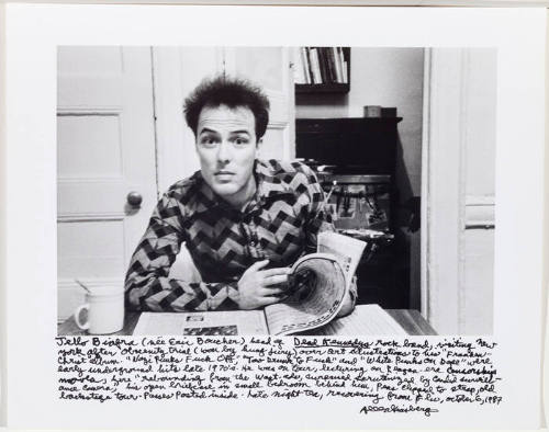 Jello Biafra at table with newspaper 1