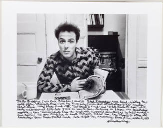 Jello Biafra at table with newspaper 1