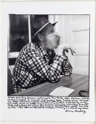 Ray Bremser in plaid shirt and hat in Allen's kitchen: variation 5 (limp wrist)