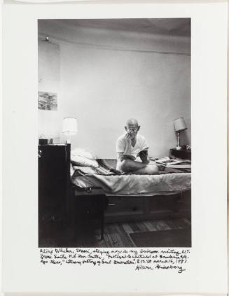Philip Whalen on bed, bare walls