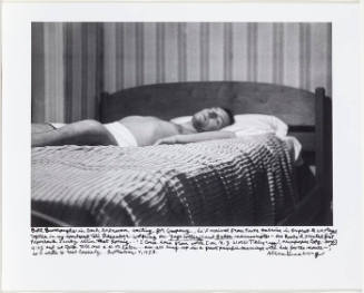 William Burroughs in bed, laying down, against striped wallpaper
