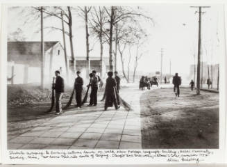 Students sweeping and burning leaves near foreign language building, Baoding, China