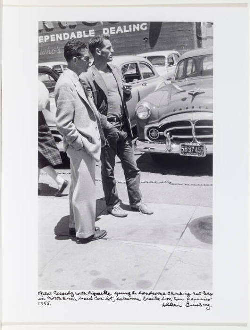 Neal Cassady at North Beach used car lot, San Francisco, standing with salesman
