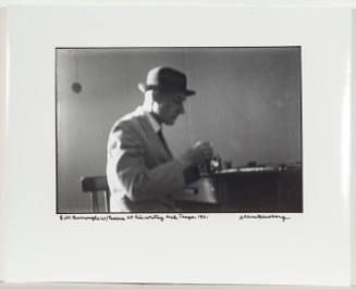 William Burroughs with camera, at his writing desk, Tangier