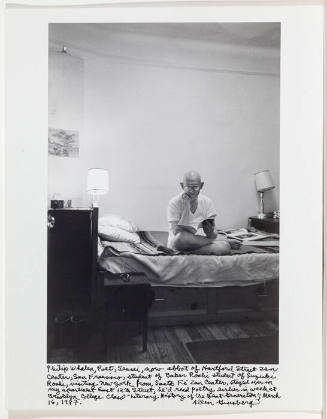 Philip Whalen on bed, bare walls