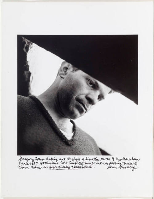 Gregory Corso looking out skylight in his attic, beat hotel