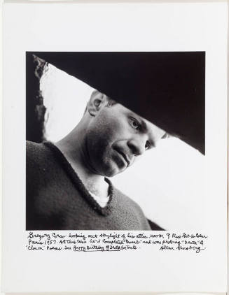 Gregory Corso looking out skylight in his attic, beat hotel