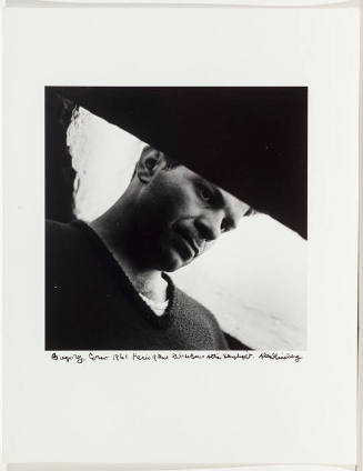 Gregory Corso looking out skylight in his attic, beat hotel