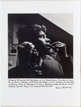 Gregory Corso looking out skylight in his attic, beat hotel, 1957