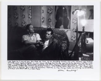 William Burroughs and Jack Kerouac both on couch, Burroughs' palm up