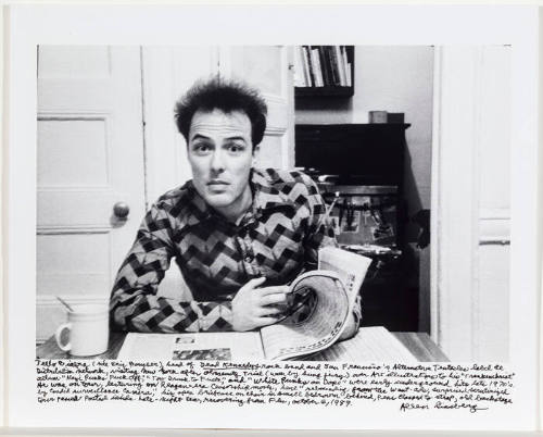 Jello Biafra at table with newspaper