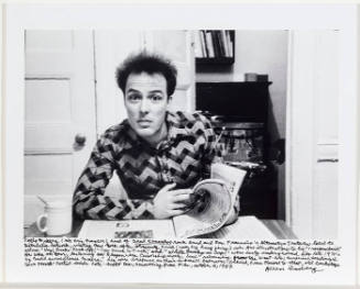 Jello Biafra at table with newspaper