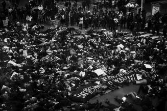 The Sum of All Parts: 3. Protesters perform a ‘die-in’ by laying on the ground at Yonge and Dundas Square in Toronto.